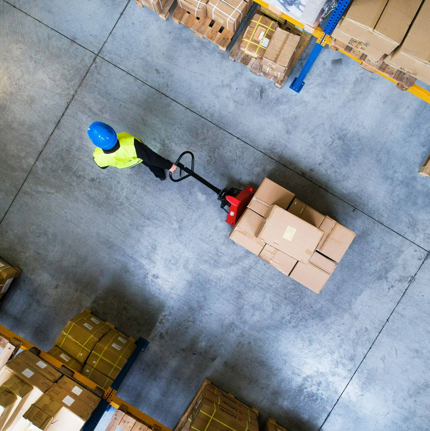 Warehouse worker moving boxes using a cart